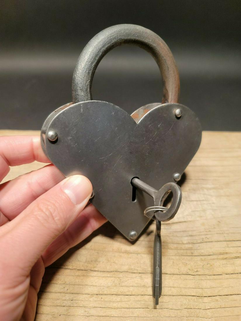 Steel Heart Bridge Padlock Lock & Key: 5" tall x 3 1/4" Wide Nice reproduction heart shaped cast iron and steel padlock! This lock is fully functional! Hard to tell its age. Heavy iron and brass. Great aged patina throughout. Limited quant