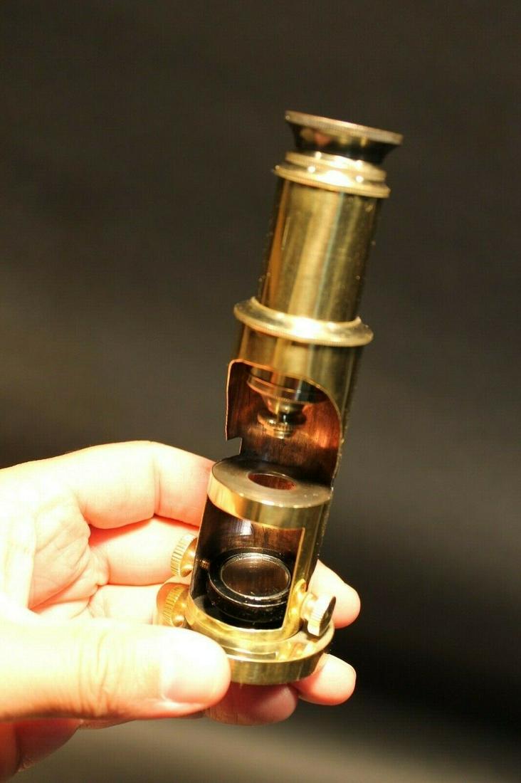 Brass Portable Microscope: 5 1/4" Tall 8" tall extended Such a neat reproduction antique microscope! This is made to look like one of the vintage portable microscopes used in field work. As shown in the images it telescopes up 