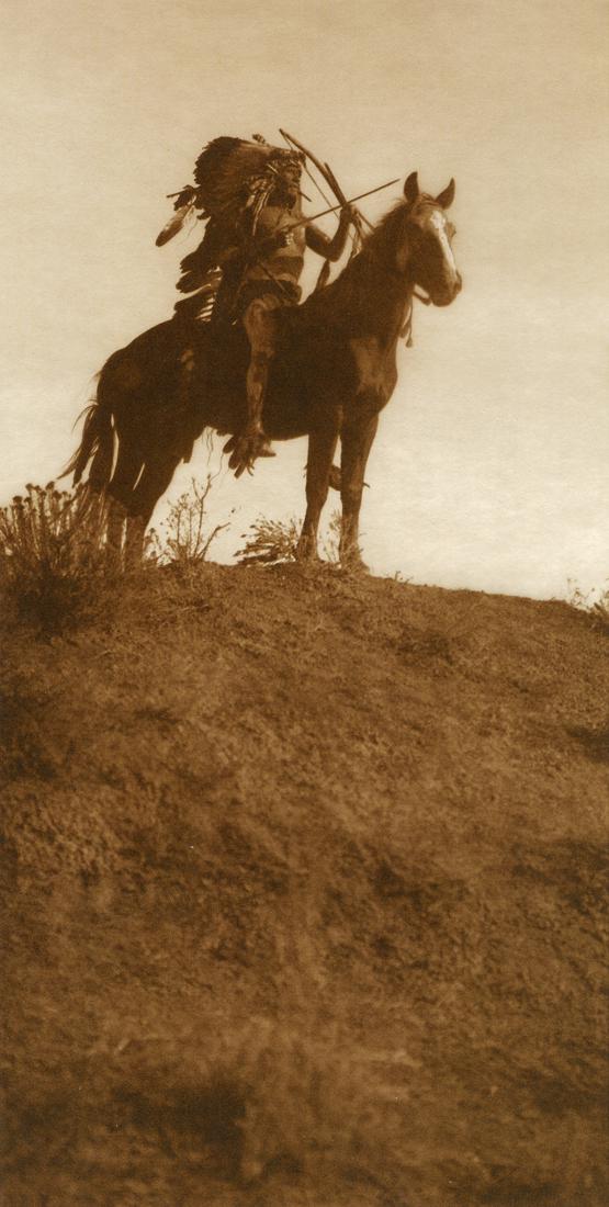EDWARD CURTIS - Ready for the Charge, Apsaroke, 1909: Artist: Edward Curtis Title: Ready for the Charge - Apsaroke, 1909 Medium: Tri-Color Photo Litho, 2004, Italy Dimensions: 5x9.95" Description: Heat Wax Mounted on 11x14" Conservation Board Artist Bio: