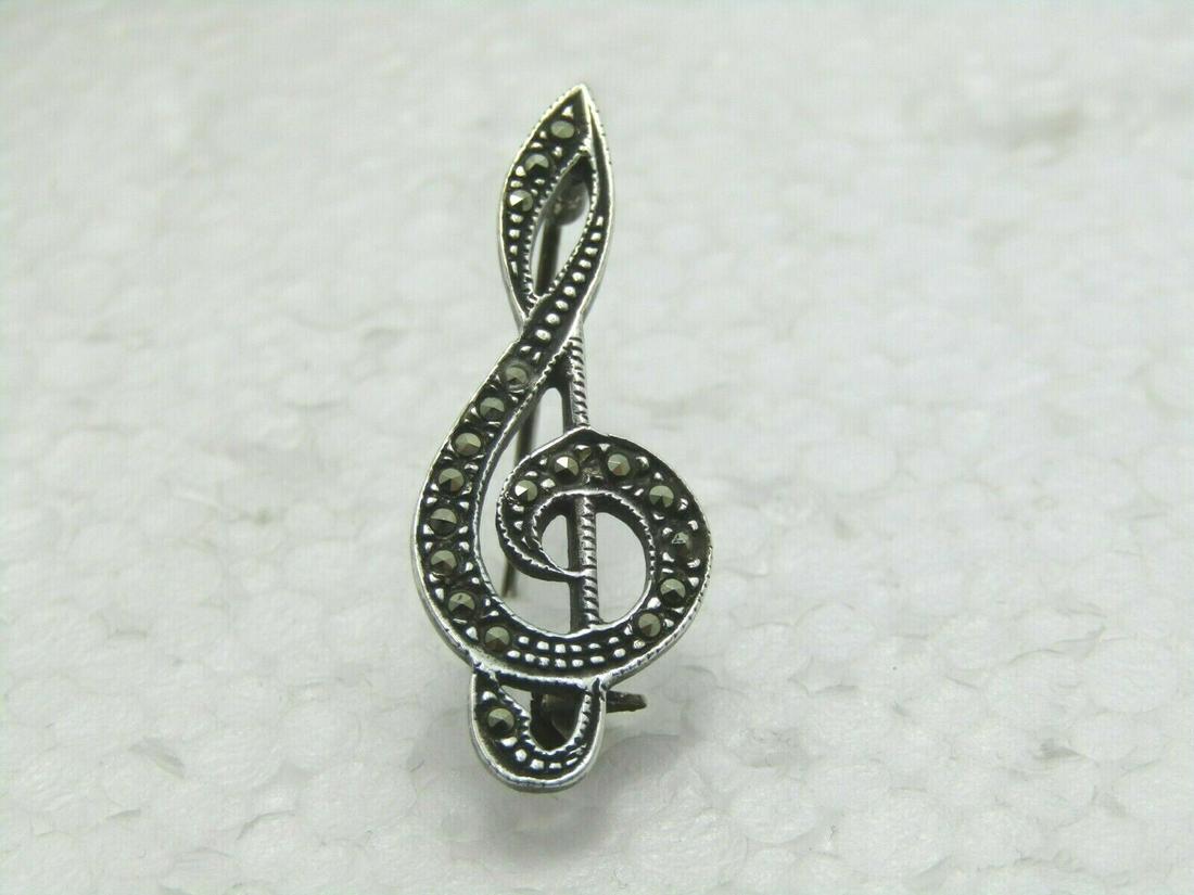 Vintage Sterling Marcasite Treble Clef Brooch, 1.5", 3.30 Gr., 1960's: Vintage Sterling Marcasite Treble Clef Brooch. It is 1.5" tall and 5/8" wide. Age is 1960's to 1980's. It has the look of marcasite but I'm not totally sure it's not just a stamped look that is made i