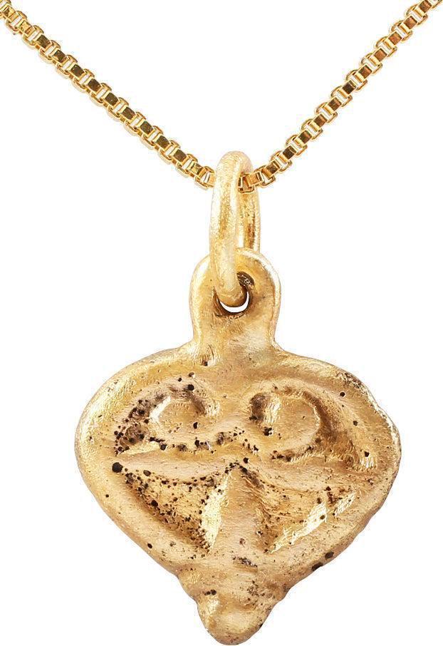 FINE VIKING HEART NECKLACE, C. 900-1050 AD: Just over 3/4" total height, of cusped top heart form. Raised rounded edge. the field with a relief trefoil, with additional sprigs to the top. The bottom point is banded for an acorn effect. The tref