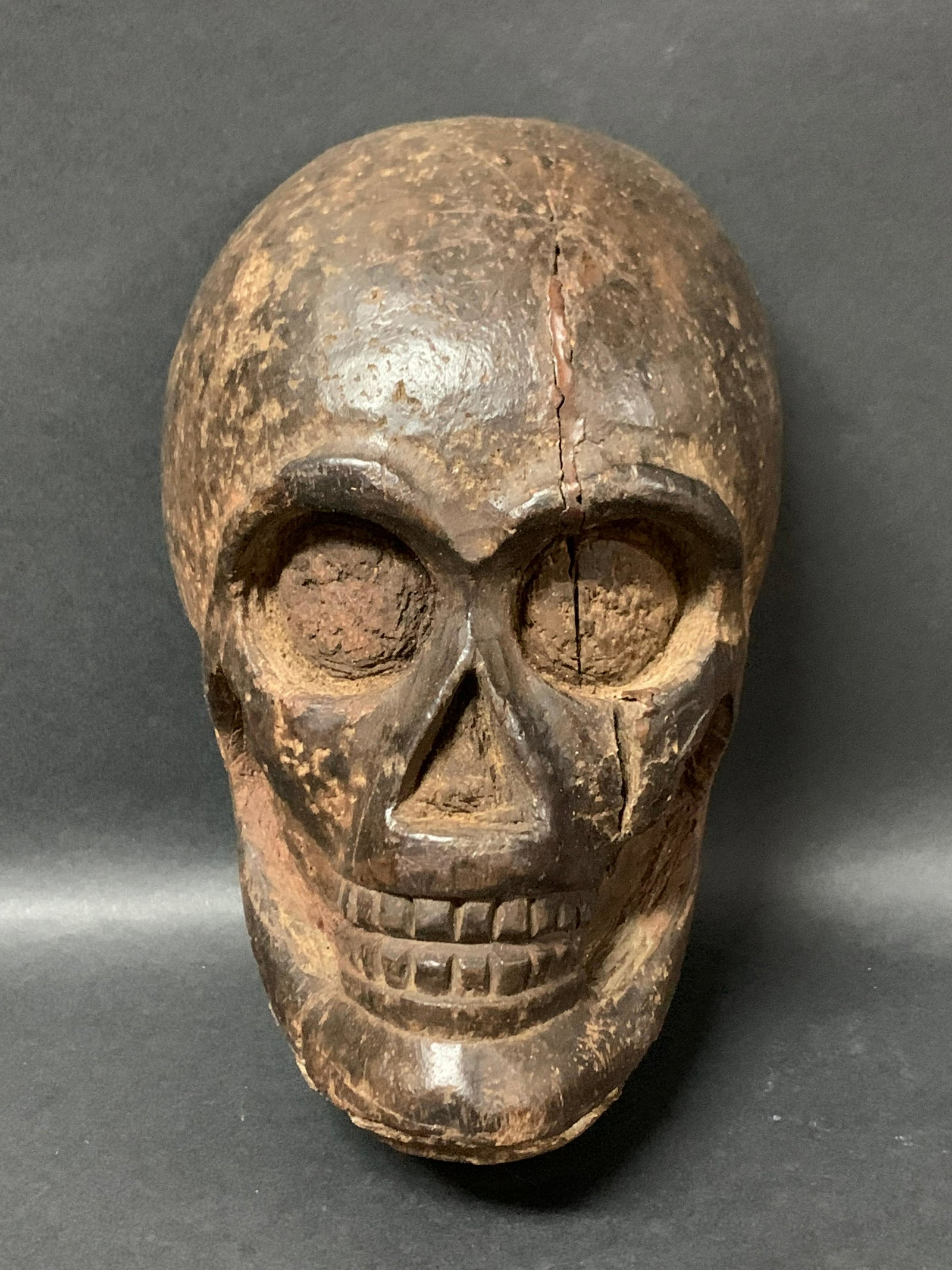 Skull: Title: Skull Date/Period: 20th Century Dimension: 8" h x 5.25" w Materials: wood Description: Carved Wood Skull. Made in the Philippines Reserve: $60.00 Shipping: Domestic: Flat-rate of $25.00 to anyw