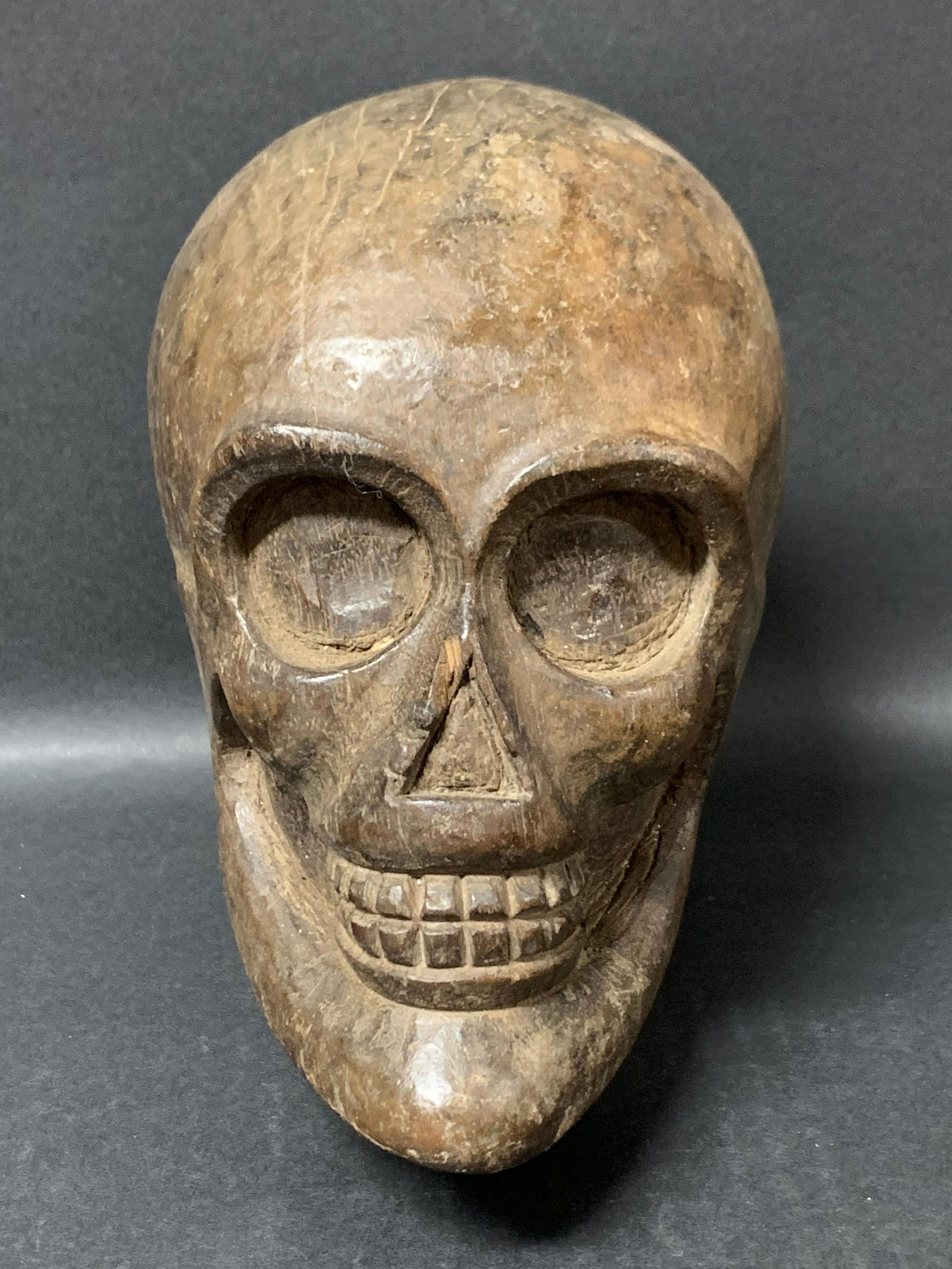 Skull: Title: Skull Date/Period: 20th Century Dimension: 8' h x 5.25" w Materials: wood Description: Carved Wood Skull Made in the Philippines Reserve: $25.00 Shipping: Domestic: Flat-rate of $25.00 to anywh