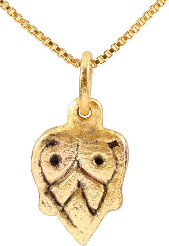 VIKING HEART PENDANT NECKLACE, C. 850-1050 A.D: Gilt bronze. 0.60" height (15.3mm"). Flat form with broad edges, the cusp terminals evolving into the upper part of the enclosed trefoil. Made by the open face mold technique. The heart stood for brav