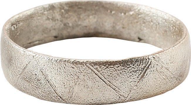 RARE VIKING DECORATED WEDDING RING, SIZE 11 3/4: 10th Century AD. Silvered bronze, large size 11 3/4. Broadband, 5.4mm, of low rounded section. Probably cast with a core as the inside shows distinct tool finishing. The face hand-cut overall in angle