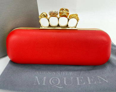 Alexander McQueen Clutch Skull 4 Rings Knuckle Clutch Red Orange Leather B226: SKU B226 1020 Pre-Owned 100% Authentic Alexander McQueen Skull 4 Rings Knuckle Clutch RATING: C..good, shows sign of use MATERIAL: leather COLOR: orange and red EXTERIOR: leather has tiny wear near