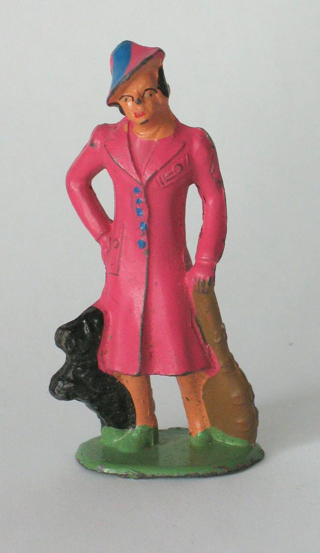Vintage Cast Metal Of A Stylishly Dressed Lady: Title: Vintage Cast Metal Of A Stylishly Dressed Lady Date/Period: 1930's Dimension: 3" high Additional Information: Nice vintage cast metal of a stylishly dressed lady in a pink outfit with her playf