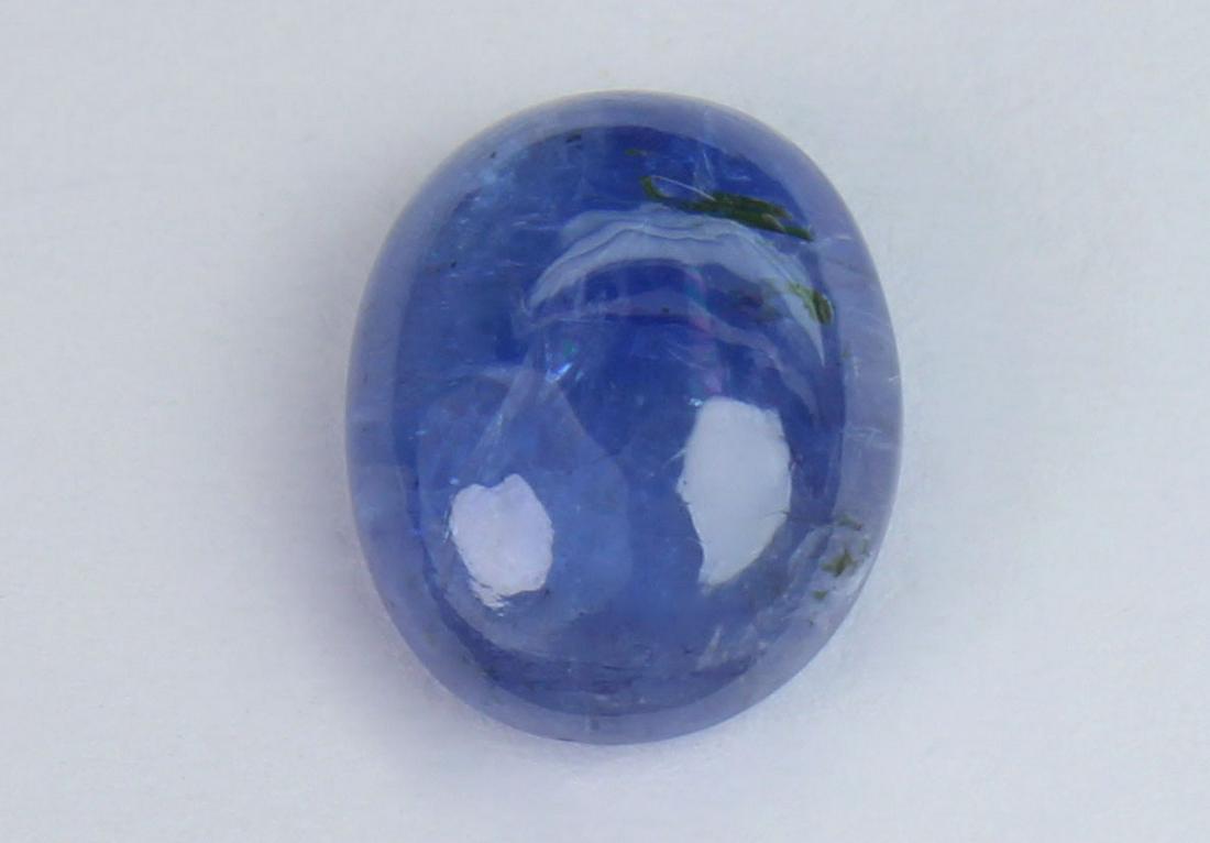 2.71 Cts Natural Tanzanite: No Reserve! Title: 2.71 Cts Natural Tanzanite Gemstone : Natural Tanzanite Shape and cut : Oval Cabochan Weight : 2.71 Carats Measurements : 9.54x7.46x4.19 mm Color : Violet Transprancy : Transparent 