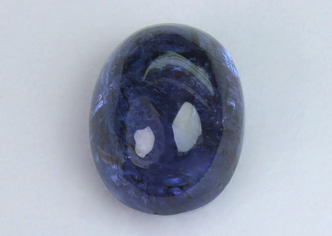 6.39 Cts Natural Tanzanite: No Reserve! Title: 6.39 Cts Natural Tanzanite Gemstone : Natural Tanzanite Shape and cut : Oval Cabochan Weight : 6.39 Carats Measurements : 12x9 mm Color : Violet Transprancy : Transparent Treatment 