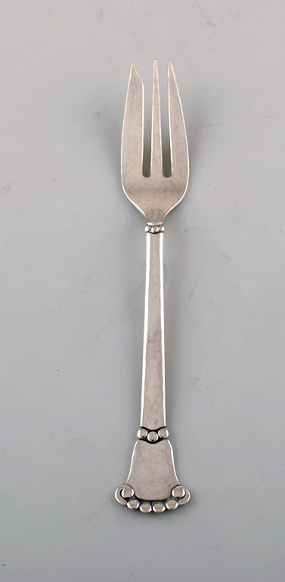 Danish silversmith. "Beaded" cake fork in hammered silver (830). Dated 1934. (1 of 4)