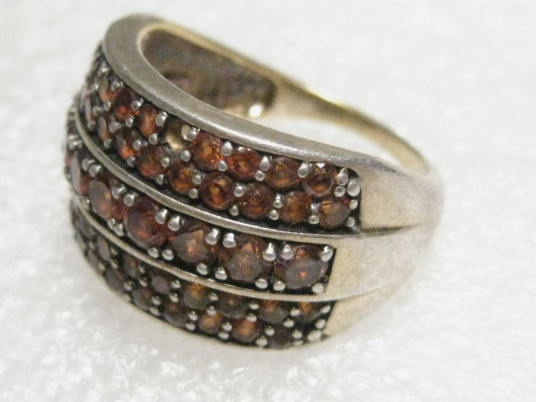 Vintage Sterling Silver Wide Ring, 5 Rows of Amber Rhinestones, Sz. 9.25, 7gr.: Vintage, sterling silver ring, that is 2/3" wide on top of the finger and slightly tiered. It has 5 rows of amber colored glass or crystal stones. Size 9.25. Weight is 7 grams. It has been worn but is