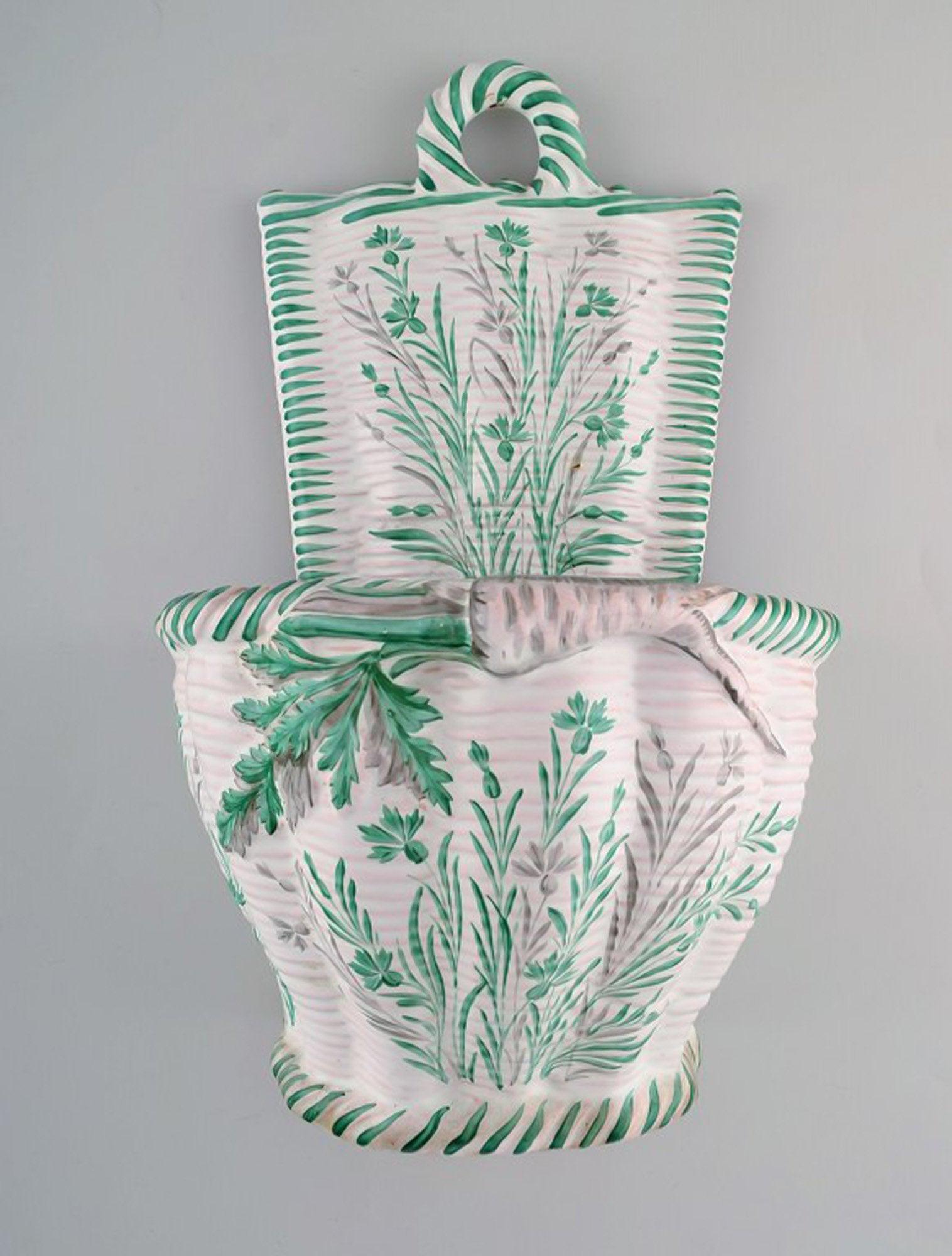 Emile Gallé (1846-1904) for St. Clement, Nancy. Large antique flower pot for wall hanging in: Emile Gallé (1846-1904) for St. Clement, Nancy. Large antique flower pot for wall hanging in hand-painted faience decorated with foliage and vegetables. 1870's. Stamped. Measures: 33 x 21 cm. In