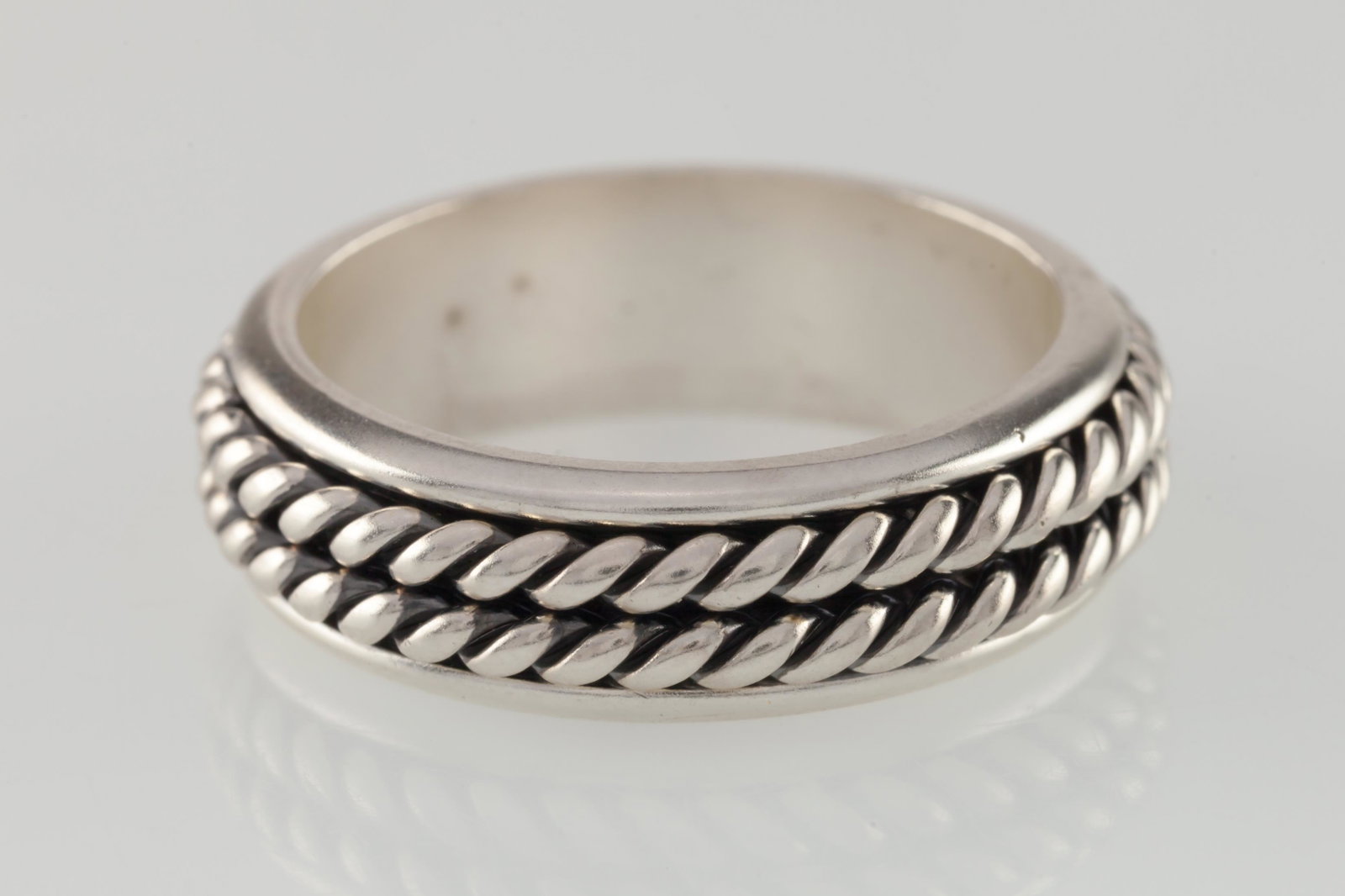 Silver Rope Band Ring: Title: Silver Rope Band Ring Description: This double rope design makes a great wedding band or everyday ring. This rings is a size 12 and weighs 10.9 grams Materials: .925 Silver Reserve: $30.00 Ship
