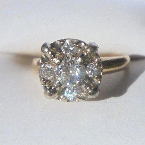 fine 14K yellow gold diamond ring size 5: Fine 14K yellow gold diamond cluster ring. High grade diamonds. Round center diamond measures 4mm diameter. Set with 4 round 2mm size diamonds . Hallmarked 14K with an aries maker symbol . Weight of 2