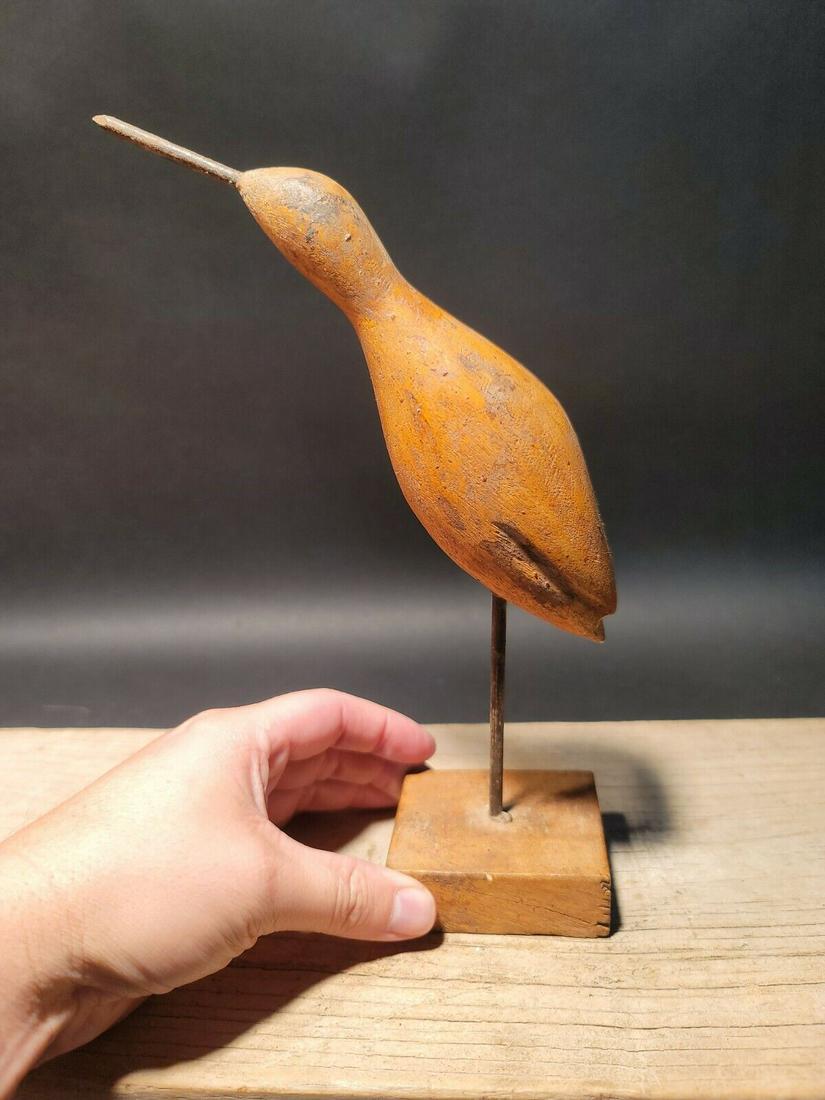 Primitive Wood Carved Shorebird Decoy: 10" tall x the base is 2 1/2" x 3" Wonderful reproduction wood carved shorebird decoy. Great decorative piece! Great signs of being hand carved, All wood with a great aged surface. The beak is made fr