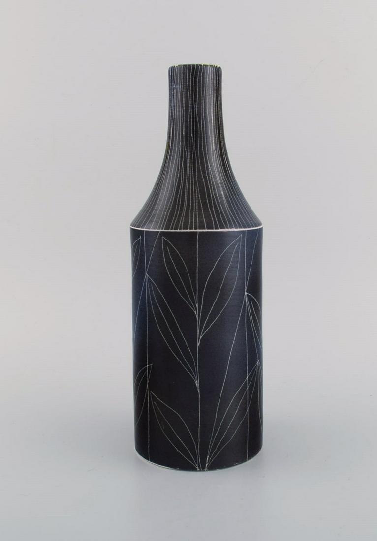 Mari Simmulson (1911-2000) for Upsala-Ekeby. Vase in glazed stoneware decorated with foliage. Model: Mari Simmulson (1911-2000) for Upsala-Ekeby. Vase in glazed stoneware decorated with foliage. Model number 4283. Mid 20th century. Measures: 29.5 x 10.3 cm. In excellent condition. Stamped. Reserve: $