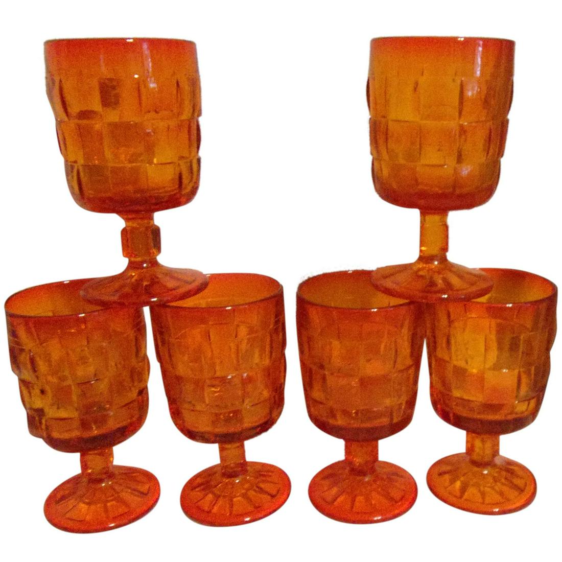 Vintage Ashley Orange Water / Tea Goblets by Viking Glass: A set of six Ashley Orange Water / Tea Goblets by Viking Glass. The goblets are orange in color and are in the ‘Ashley’ pattern. The pattern is characterized by its basket weave pattern an