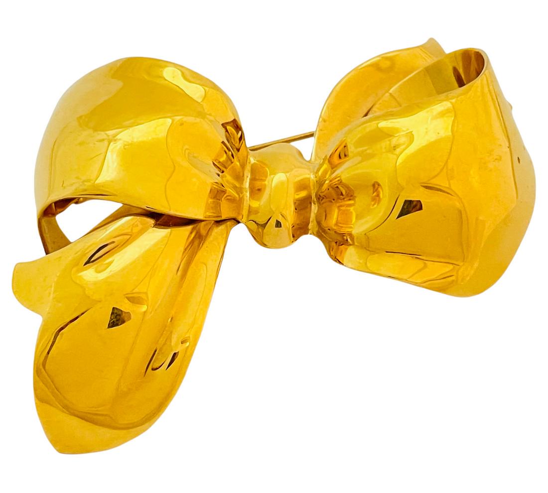 Vintage MONET huge bow gold shiny designer runway brooch: Details: Signed MONET gold tone vintage designer runway brooch MEASUREMENTS: 3 1/2" by 2 1/4 CONDITION: excellent vintage condition with minimal signs of wear Reserve: $94.00 Shipping: Domestic: Flat-