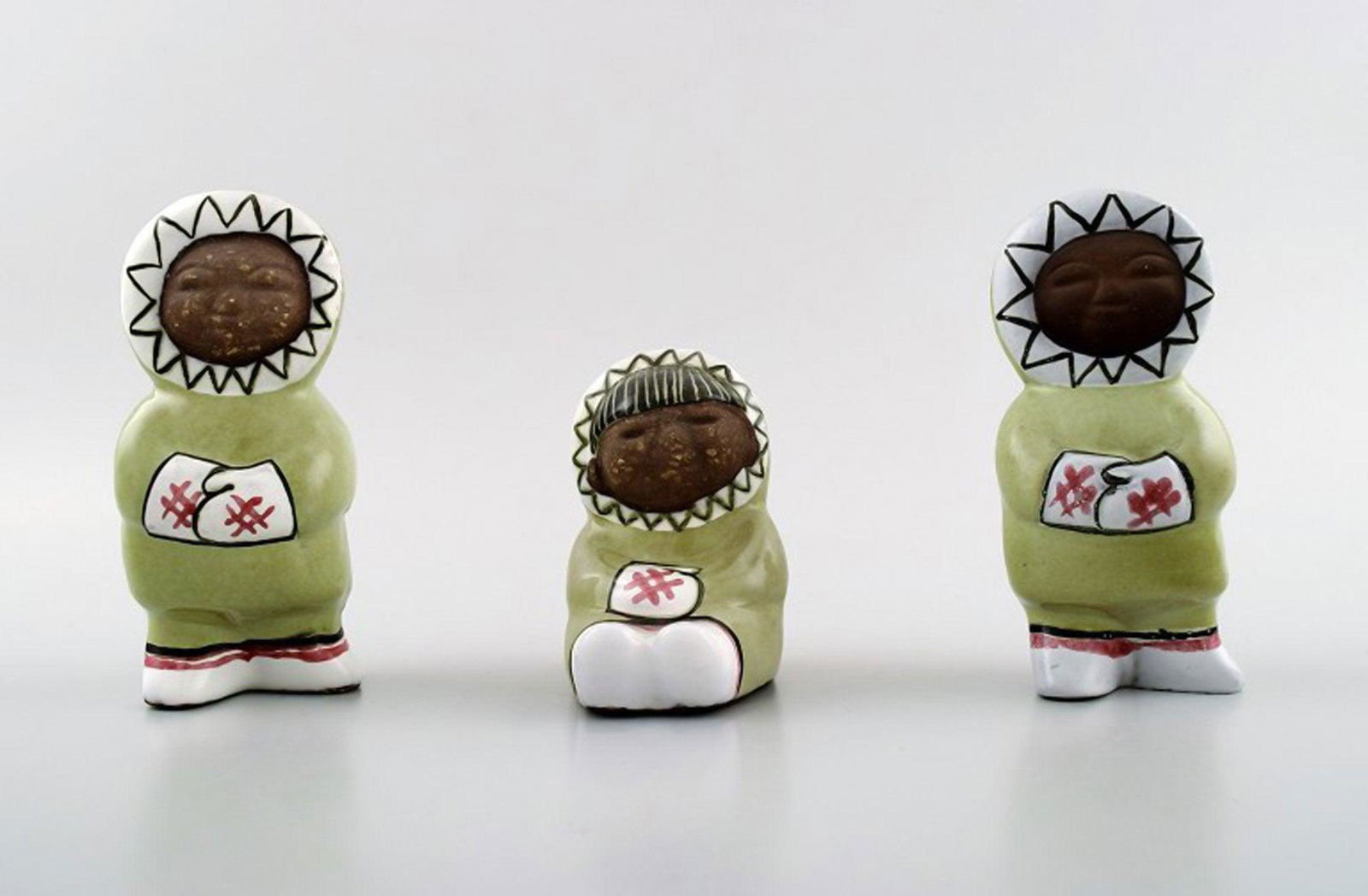 Collection of Upsala-Ekeby art pottery figurines, Eskimo children.: Collection of Upsala-Ekeby art pottery figurines, Eskimo children. Total of three figures. Sweden mid. 20 c. Marked. Model number 4297. In perfect condition. Measures 10.5 cm. x 3 cm. Reserve: $210.00