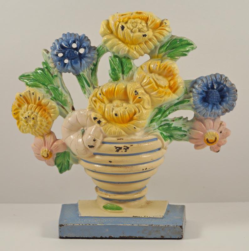 Marigold Flower Cast Iron Hubley Doorstop: Title: Marigold Flower Cast Iron Hubley Doorstop Dimension: 7 ¾” tall x 8” wide. Date: Ca. 1930’s. Additional Information: Charming array of Marigolds in ribbed Vase cast iron A