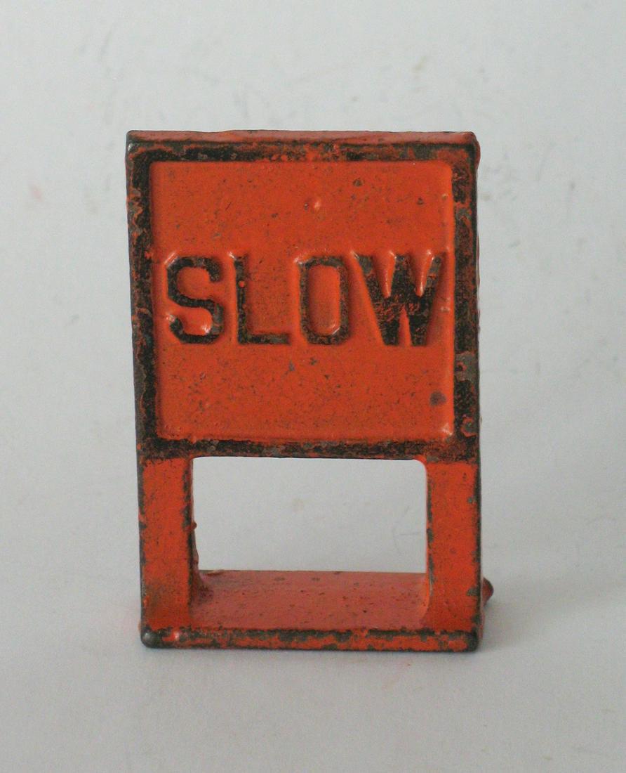 Vintage cast iron Arcade toy “SLOW” sign.: Title: Vintage cast iron Arcade toy “SLOW” sign. Date/Period: 1930”s Dimension: 2 1/4” high Additional Information: Nice vintage cast iron Arcade toy sign “SLOW” in