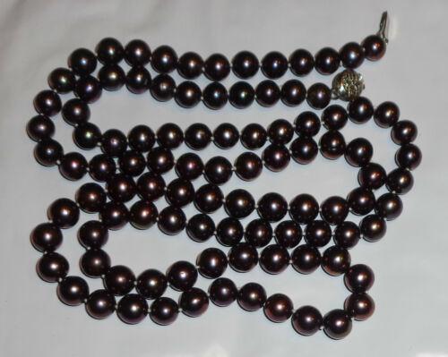 fine 7mm cultured black pearl necklace 35": Fine black cultured pearl necklace. 7mm round fresh water culture. High grade roundness and smooth surfaces. Measures 35" long. Very fine condition. Knotting between pearls. White gold plated filigree