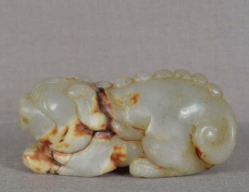 Chinese jade carving CHIMERA: 1930s Chinese jade carving of a crouching hornless chimera with bumpy spine and bifurcated tail. Beautiful true nephrite jade of celadon color with rich rust/brown color veining, very good carving, gr