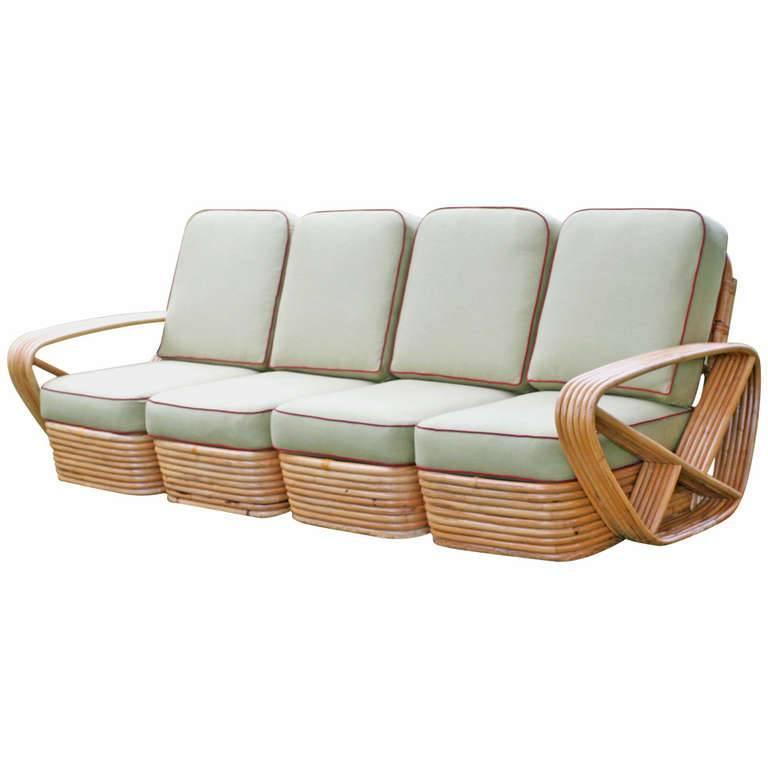 Restored Square Pretzel Rattan Four-Seat Sofa: Square pretzel rattan sectional sofa in the Paul Frankl style. This sofa features a stacked rattan base with six strand square pretzel arms and is divided into four personal sectionals. Please inquire