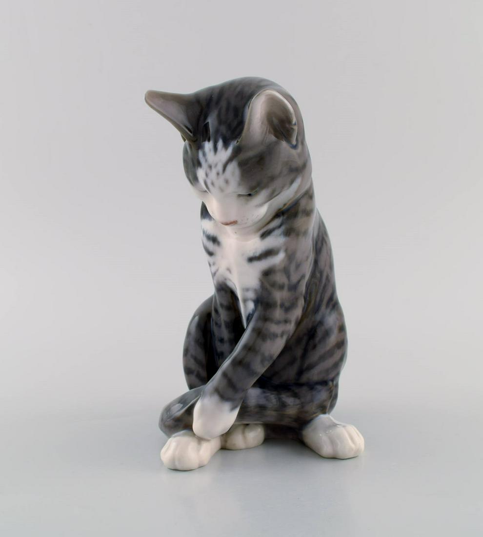Erik Nielsen for Royal Copenhagen. Porcelain figure. Grey-striped cat. Model number 1025/340. Dated (1 of 8)