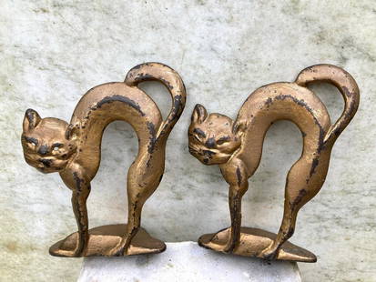 Pair cast iron arched cat bookends: 5&#8221; high. Original gold paint with some paint wear. Iron is in good condition. Shipping: Domestic: Flat-rate of $16.00 to anywhere within the contiguous U.S. International: Foreign shipping rates