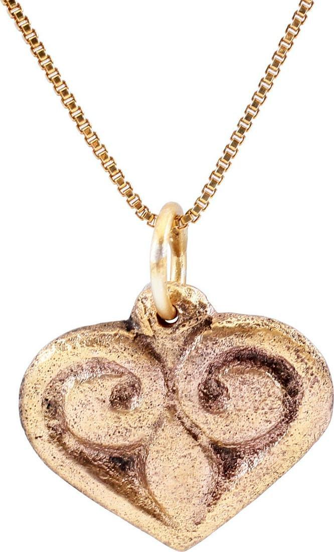 FINE ANCIENT VIKING HEART PENDANT NECKLACE, C.900 AD: Exceptional example of the fully evolved form. Deeply modeled with rounded edges and concave back made by the open face mold technique. The cusped top heart indicative of a full transition from the na