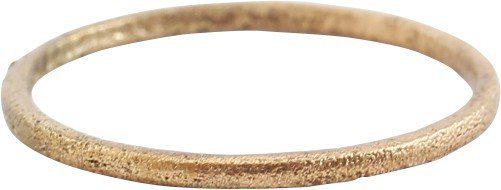 VIKING WEDDING RING 4 1/4.: Late 9th-early 11th century AD. Gilt bronze, size 4 1/4 for wear on the small finger, between the first two joints as was the custom. 1.1mm thick rounded face band. Textured from burial and profession