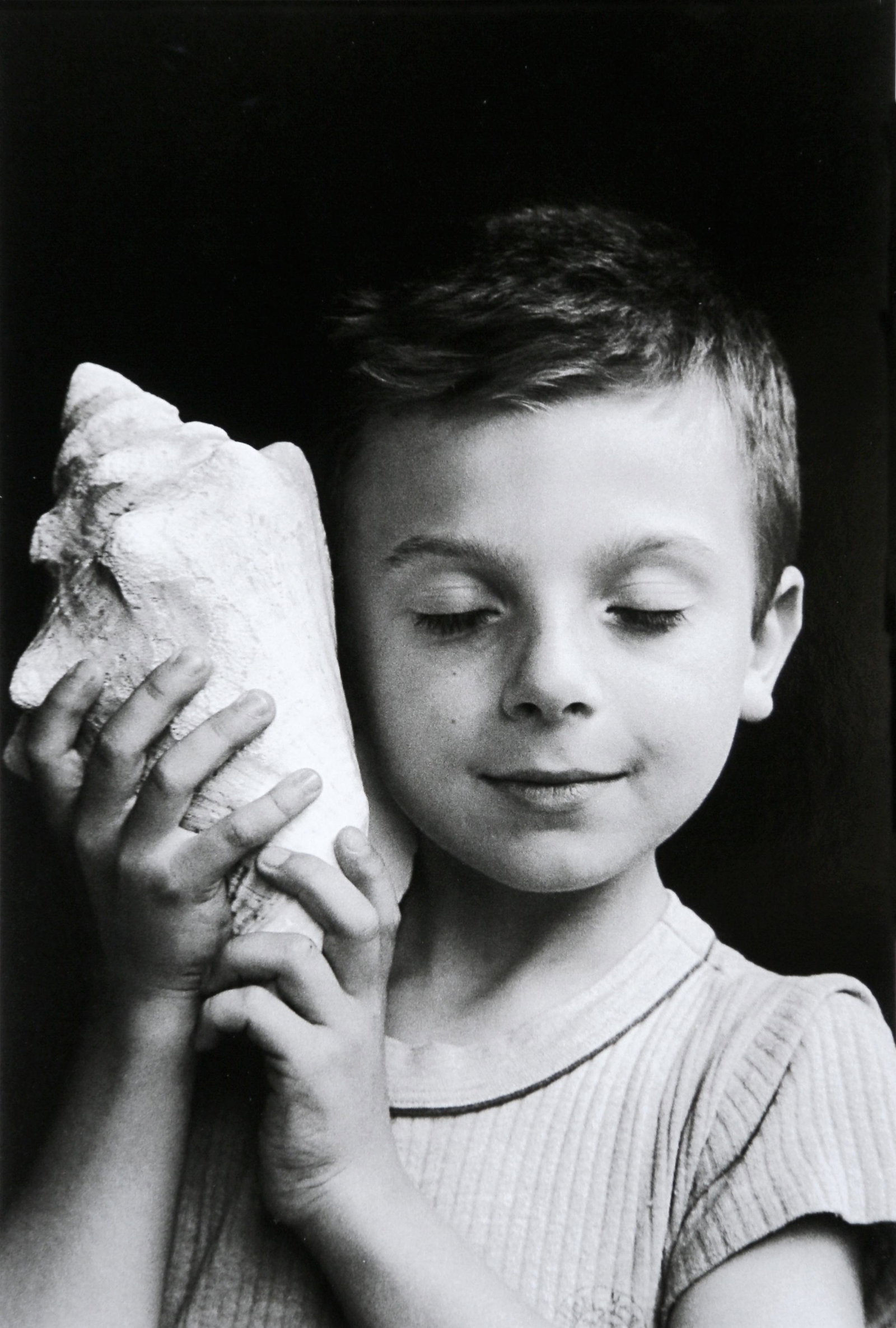 Edouard Boubat: Remy listening the sea, Paris: Artist: Edouard Boubat Title: Remy listening the sea, Paris Date Printed: 2008 Medium: High Quality Offset Photo Print with Copyright Edouard Boubat/RAPHO/EYEDEA Print Origin: Printed in Italy - Portf