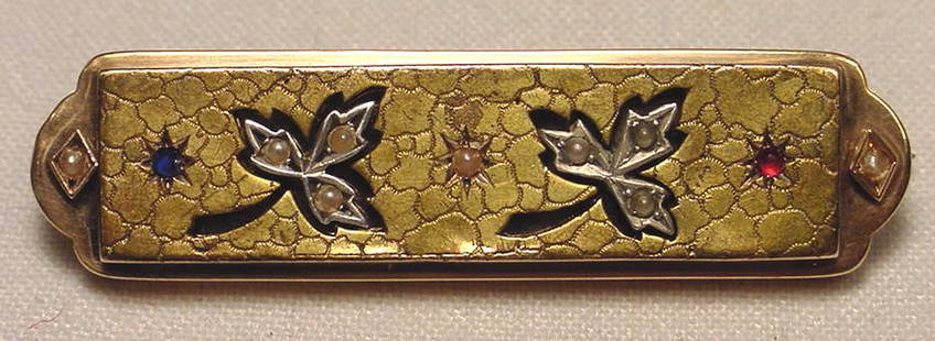 Art Nouveau Gold Ruby Sapphire Pearl Brooch: Title: Art Nouveau Gold Ruby Sapphire Pearl Brooch Additional Information: Beautiful antique Art Nouveau 14K gold sapphire ruby pearl and platinum set brooch. The brooch measures 2 1/4 inches wide.