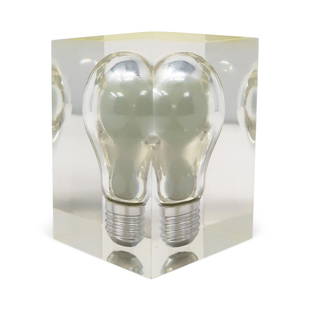 1970s Floating Light Bulb in Lucite Sculpture by Pierre Giraudon: A striking and whimsical late mid-century sculpture, paperweight, and crowd-pleasing decor item, this piece was designed by Pierre Giraudon, an artist and designer known for suspending items in lucite