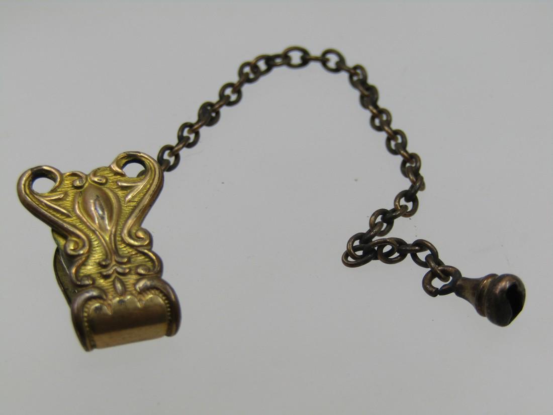 Victorian 9kt. G.F. Hinged Clip with Chain, 1800's, 5",: Victorian 9kt. G.F. Hinged Clip with Chain, 1800's, 5", this has a hinged scrolled clip that tests as 9kt gold filled. It is appx. 7/8" long and 1/2" wide. A chain slightly longerly than 4" drops from