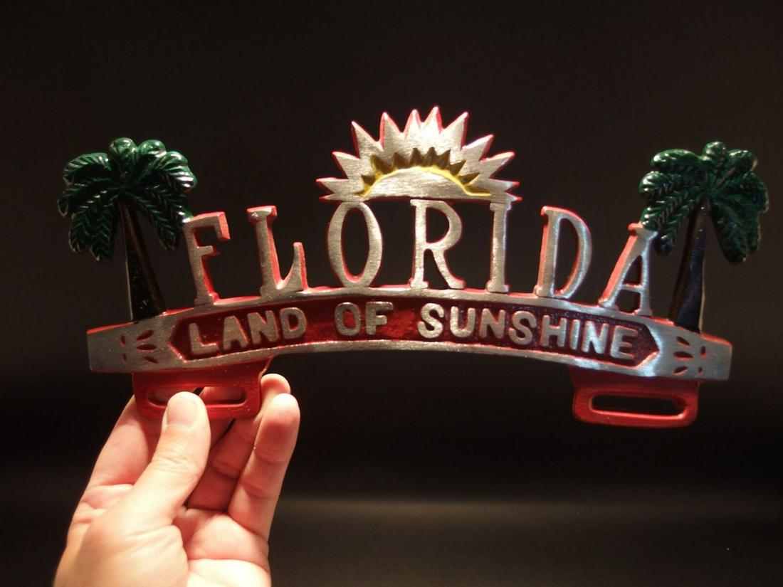 Florida "Land of Sunshine" License Plate Frame: 12" Long 5 1/2" tall 1/8" thick Such a neat accurate reproduction aluminum license plate frame. This frame is all solid metal, hand painted. I checked it with a magnet it doesn't attract. Reserve: $28