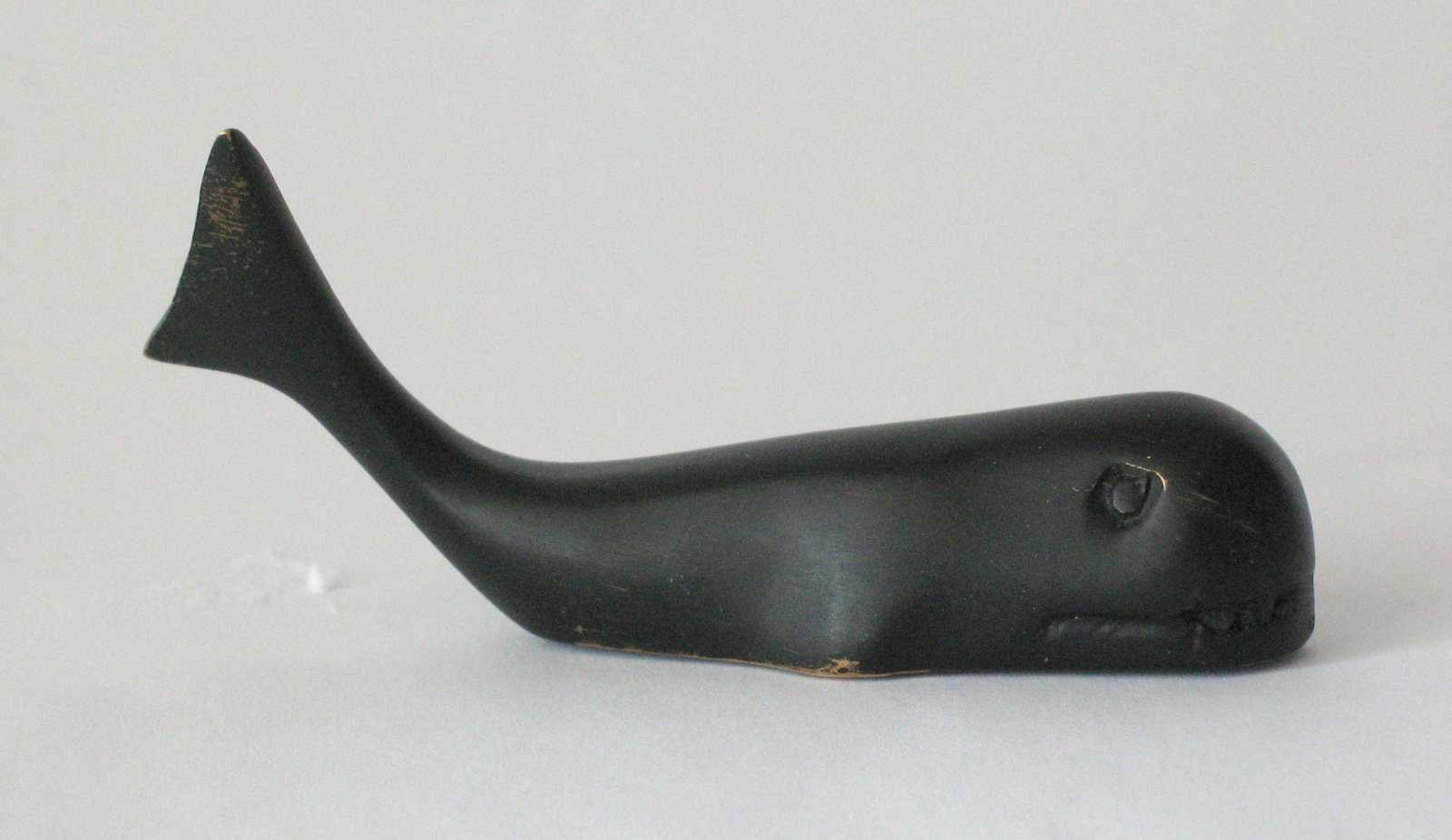 Vintage cast brass whale chart weight.: Title: Vintage cast brass whale chart weight. Description: Nice vintage cast brass whale chart weight in old black paint with a nice patina. Dimensions: 3” long Circa: 1950's Shipping: Domestic: