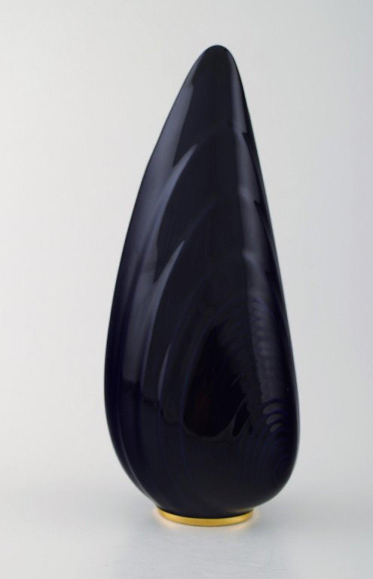 Upsala-Ekeby / Karlskrona. Ceramic Vase, navy blue glaze with gold decoration at the bottom.: Upsala-Ekeby / Karlskrona. Ceramic Vase, navy blue glaze with gold decoration at the bottom. Clamshell shaped. Stamped. Sweden 1960 s. In perfect condition. Measures 29 cm. x 10 cm. Reserve: $210.00 S