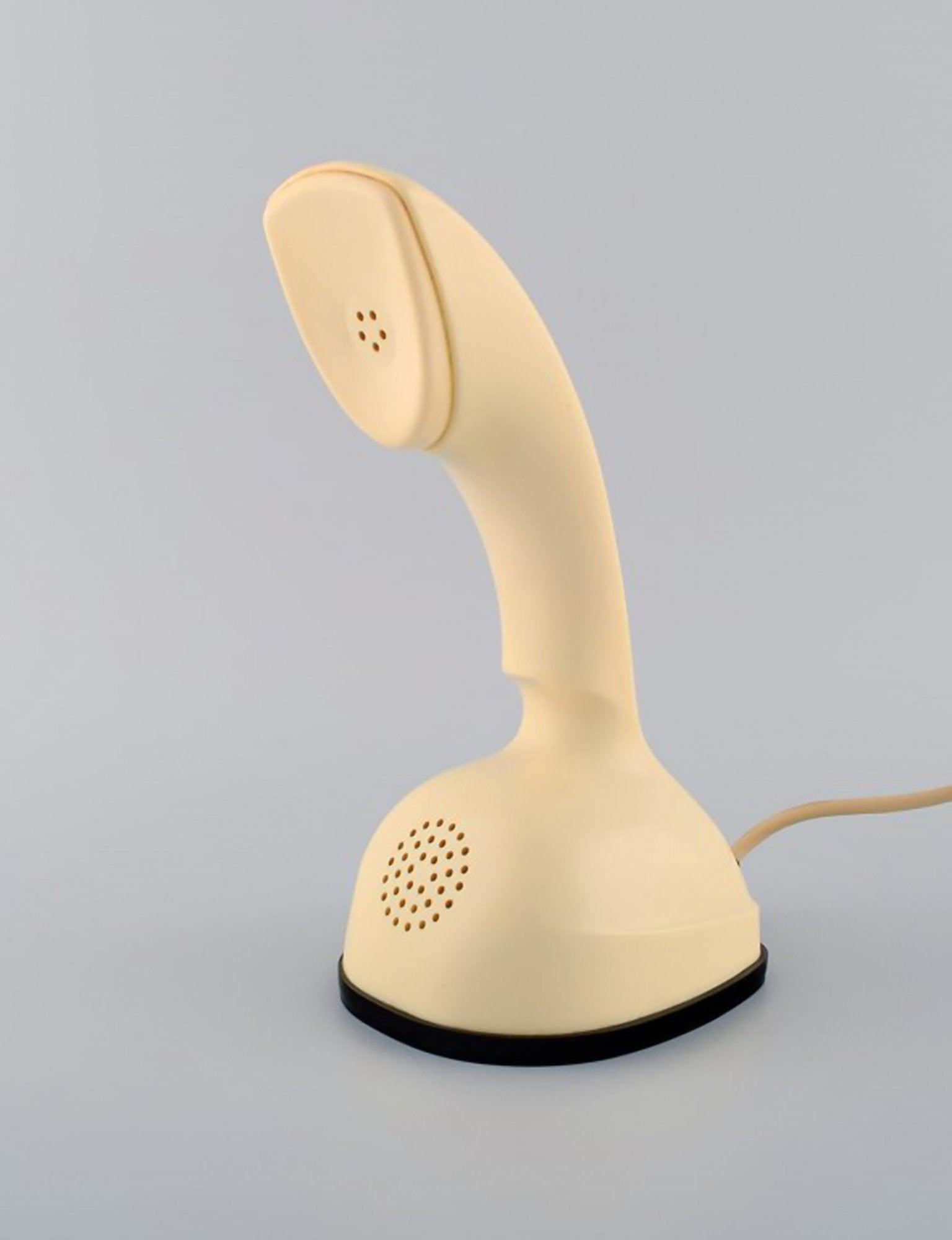 Ericsson Cobra phone in cream-colored plastic with turntable at the bottom. Swedish design icon,: Title: Ericsson Cobra phone in cream-colored plastic with turntable at the bottom. Swedish design icon, 1960's. Description: Ericsson Cobra phone in cream-colored plastic with turntable at the bottom.