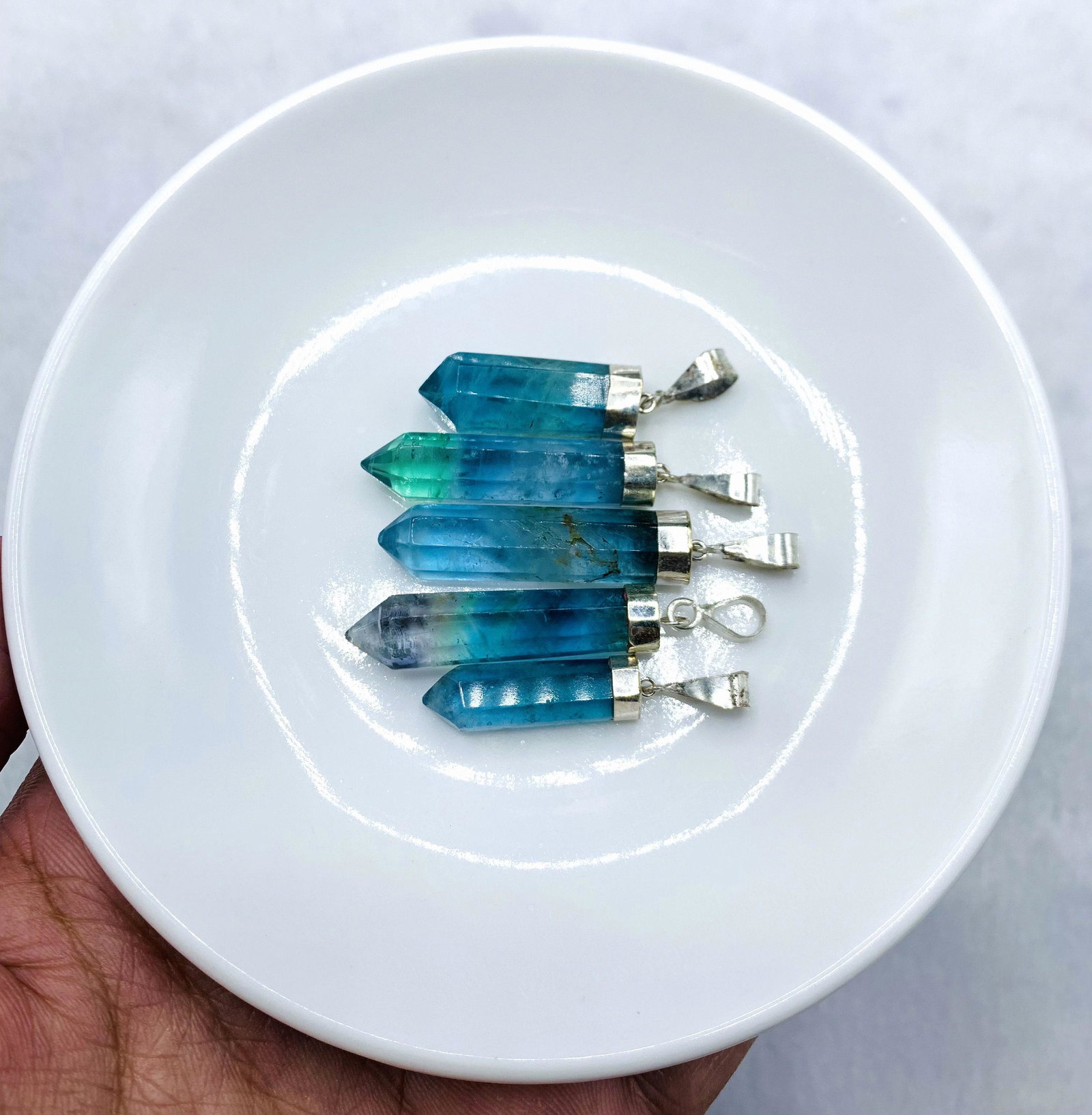 5 Pieces Beautiful Fluorite Pendants Sterling With 925 Silver: Description Crystal size 24x7x6mm to 36x7x6mm weight 24 Grams Code A315 Reserve: $14.00 Shipping: Domestic: Flat-rate of $12.00 to anywhere within the contiguous U.S. International: Foreign shipping r
