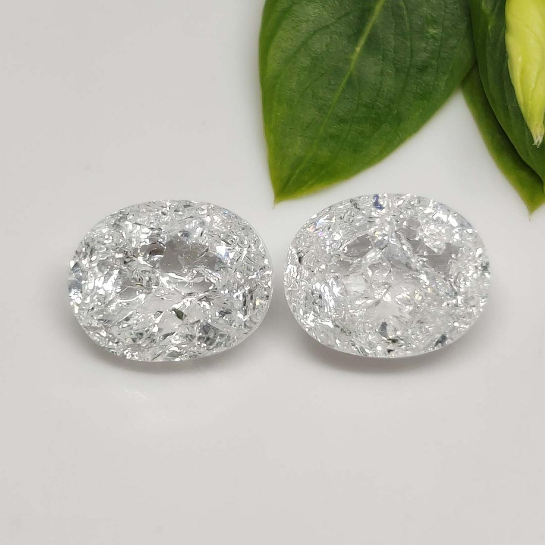 5.40 ct Rare Natural White Crackled Quartz Pair: No Reserve! Title: 5.40 ct Rare Natural White Crackled Quartz Pair Additional Information: Gemstones: Natural Crackled Quartz Carat Weights: 5.40 ct Size/Dimensions: 10 X 8 mm Materials & Techniques: 