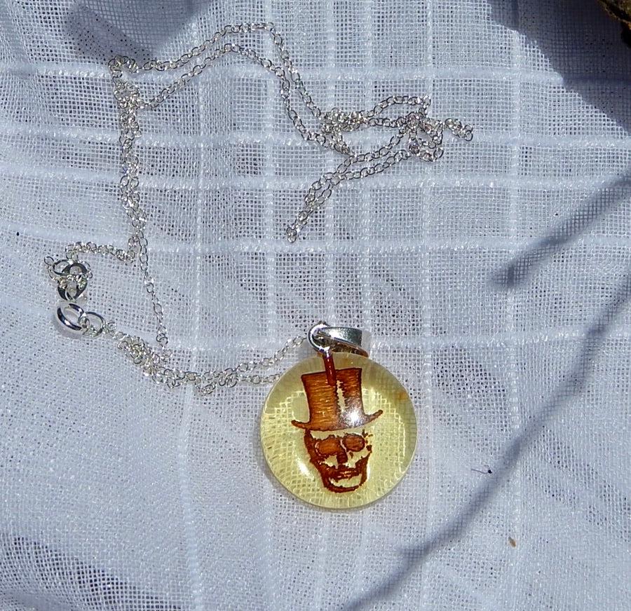 Genuine Baltic Amber Laser Cut Skull Pendant in 925 Silver: Title: Genuine Baltic Amber Laser Cut Skull Pendant in 925 Silver Additional Information: Genuine Baltic amber skeleton head necklace set in 925 silver This is a fantastic piece! One of a kind. The sk