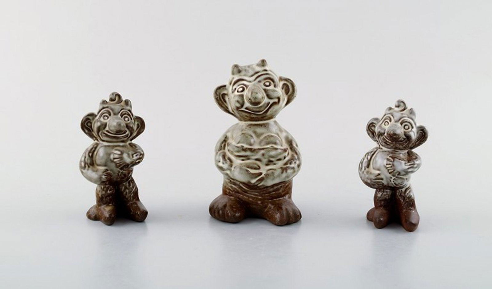 Michael Andersen Ceramics from Bornholm. Three hand-painted figures. Designed by Ludvig Mahler.: Michael Andersen Ceramics from Bornholm. Three hand-painted figures. Designed by Ludvig Mahler. "Krøllebølle"-family. Largest measures: 11 cm x 8 cm. Perfect condition. Reserve: $95.00 Shipp