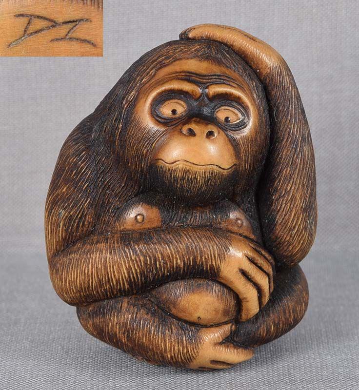 Netsuke PERPLEXED APE by DOUG MARSDEN: Wooden netsuke of perplexed ape (looks like orangutan) by contemporary New Zealand netsuke carver Doug Marsden (b. 1958). Superb quality carving to the last detail, extraordinary face with horn inlaid