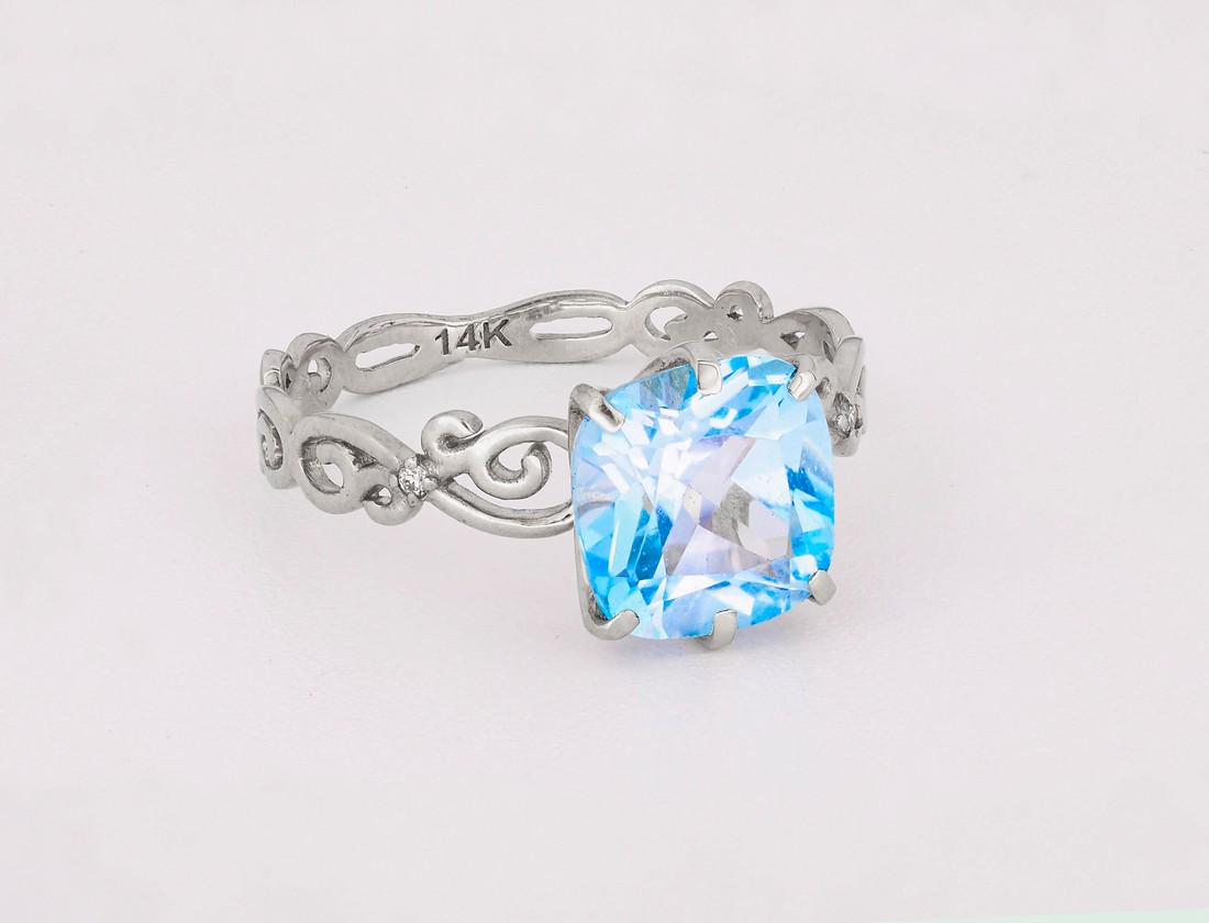 Gold ring with topaz and diamonds.: Title: Gold ring with topaz and diamonds. Additional Information: Gold ring with topaz and diamonds. 14kt white gold Weight: 2.00 g. Central stone topaz, color - blue couchion cut, approx 3 ct. in tot