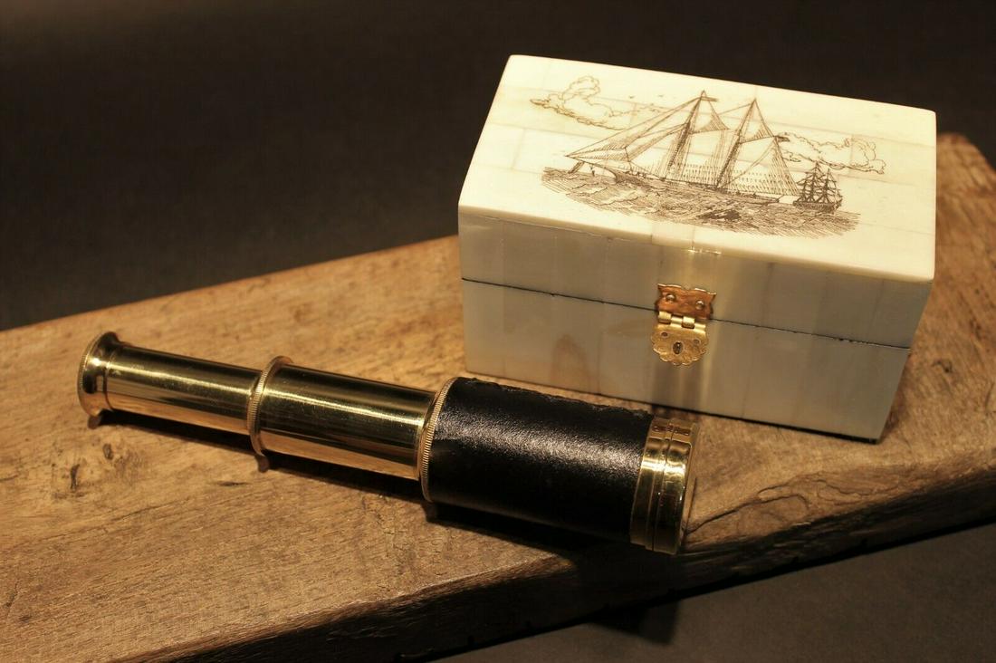 Sailboat Bone & Wood Scrimshaw Box w Telescope: Box measures 4 3/4" Long x 2 5/8 wide x 2 5/8" tall Telescope measures 3 3/8" Long closed x 6 1/4" open Nice quality reproduction of a traveling pocket telescope and cap. This piece is all brass wrapp