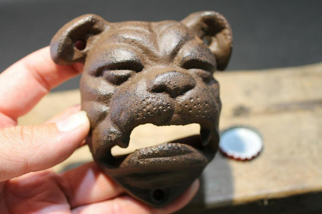 Cast Iron wall mount folk art Bulldog Beer Bottle Opener: 4" Tall x 3 1/2" Wide Such a neat reproduction antique cast iron bulldog wall mounted bottle cap opener. The mouth of the bulldog is where you would open the bottle. Certainly a great accent piece! Be