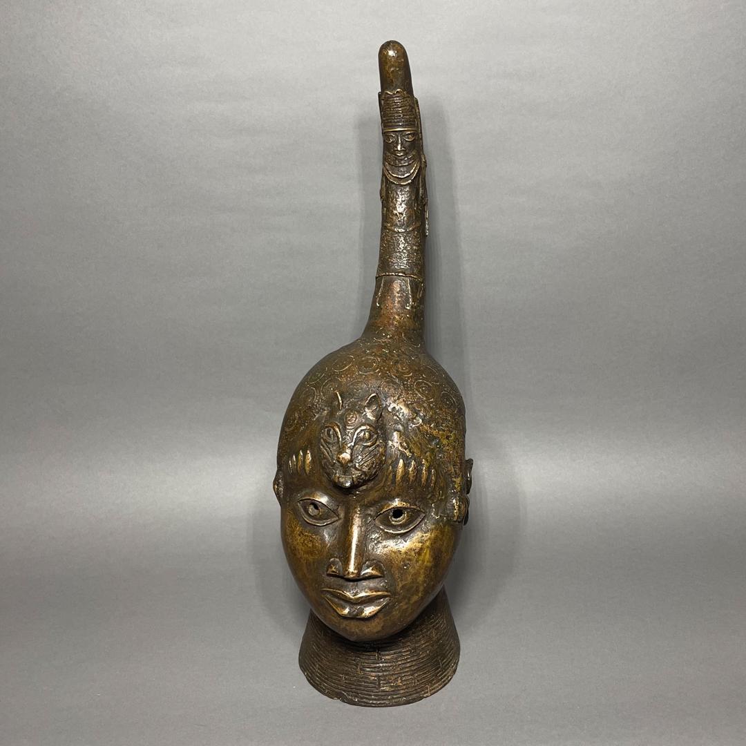 Benin Kingdom Bronze Head: Title: Benin Kingdom Bronze Head Date/Period: 18th Century Materials/Origin: Nigeria, Africa Dimension: 21in x 7in x 7in Reserve: $500.00 Shipping: Domestic: Flat-rate of $50.00 to anywhere within the