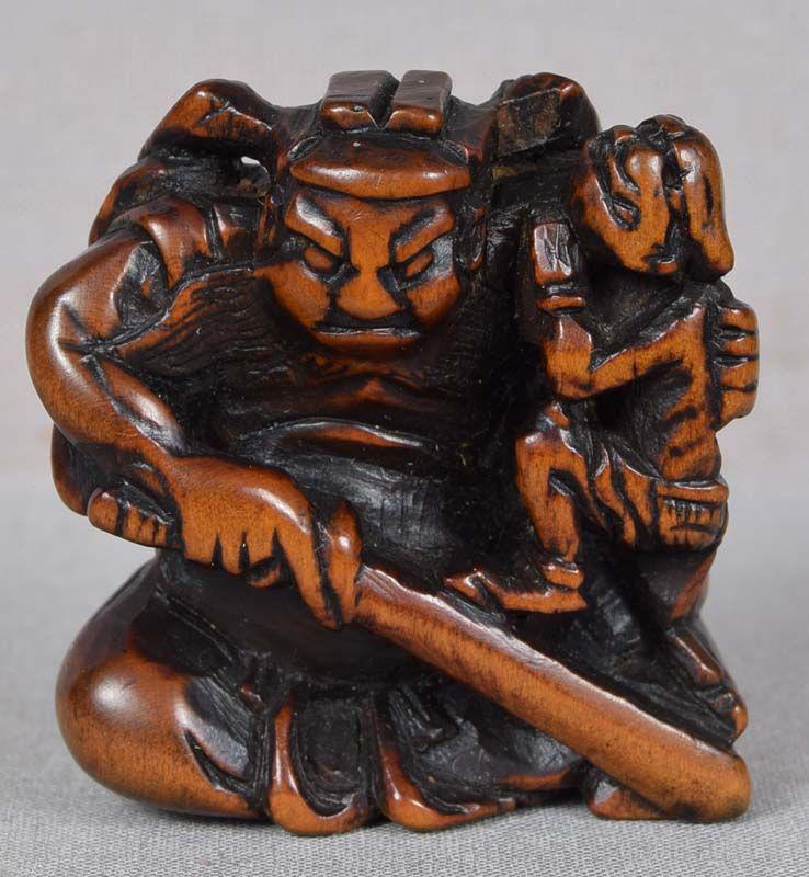 Early 19c netsuke boxwood SHOKI & ONI: Early 19th century boxwood netsuke of Shoki (demon queller) with a drawn sword in one hand, and holding a panicking oni with the other. Very strong early carving, especially of Shokiâ€™s fierce a